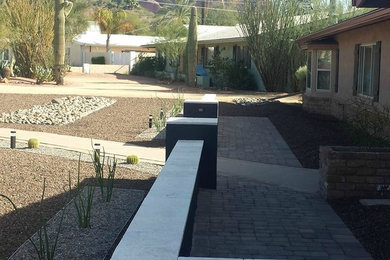 Design ideas for a mid-sized contemporary front yard brick landscaping in Phoenix.
