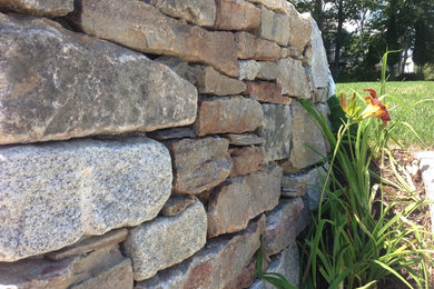 Inspiration for a backyard retaining wall landscape in Manchester.
