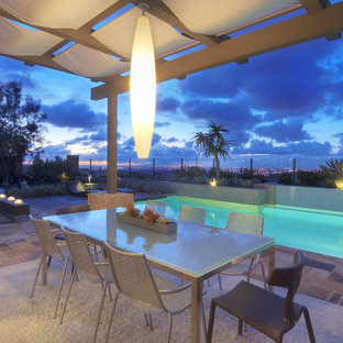 Photo of a large modern partial sun backyard stone landscaping in Orange County.