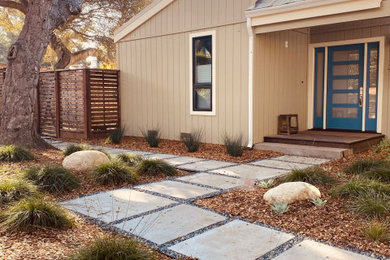 This is an example of a mid-sized modern drought-tolerant and partial sun front yard stone and wood fence garden path in San Francisco.