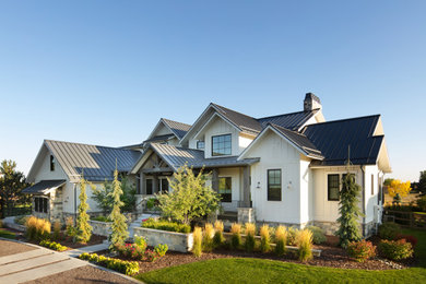 This is an example of a large farmhouse partial sun front yard gravel landscaping in Denver.