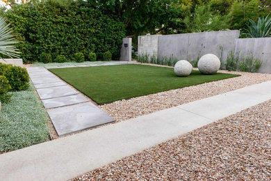 Design ideas for a mid-sized modern full sun front yard stone landscaping in Austin for spring.