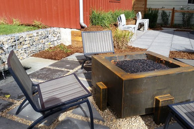 Inspiration for a mid-sized modern partial sun backyard concrete paver water fountain landscape in Denver for summer.