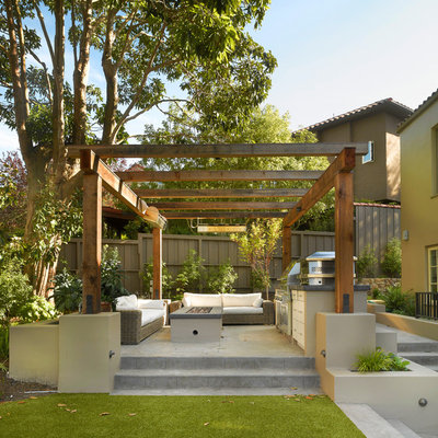This is an example of a mid-sized backyard stone landscaping in San Francisco with a fire pit for summer.