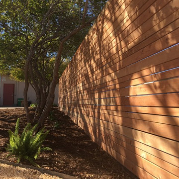 Modern, redwood rough-sawn horizontal panel fence
