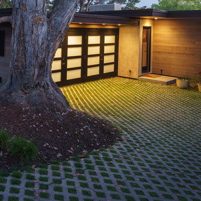 Photo of a large mid-century modern front yard concrete paver driveway in San Francisco.
