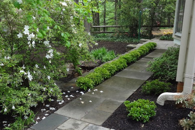 This is an example of a medium sized contemporary side partial sun garden for autumn in DC Metro with natural stone paving.