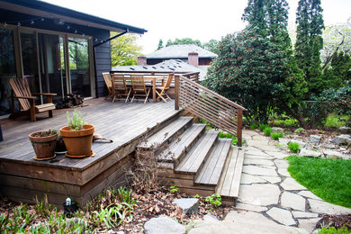 Design ideas for a mid-sized modern partial sun backyard landscaping in Portland with decking.