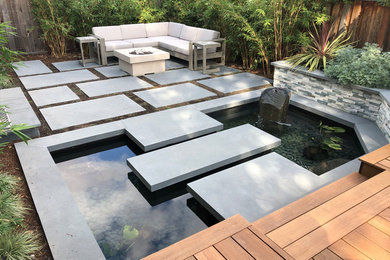Inspiration for a small modern backyard pond in San Francisco with decking.
