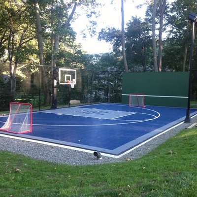 This is an example of a small traditional partial sun backyard concrete paver outdoor sport court in Boston.