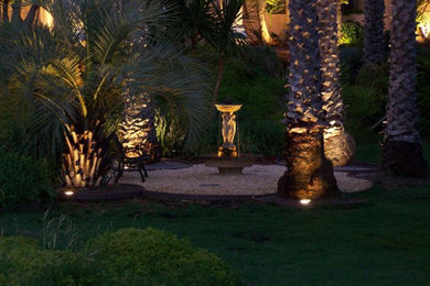 Inspiration for a mid-sized tropical backyard gravel water fountain landscape in Orange County.