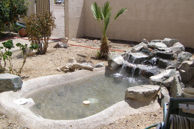 Design ideas for a backyard gravel water fountain landscape in Phoenix.