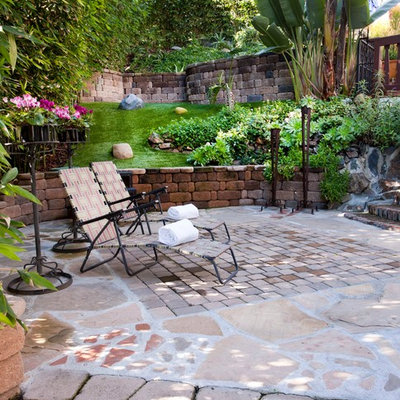 Photo of a mediterranean hillside brick landscaping in San Diego.