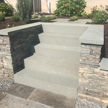 Natural antique bluestone wall with plantings and bluestone steppers