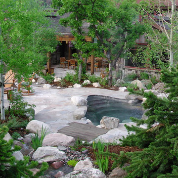 Natural spa and stream water feature with patio seating