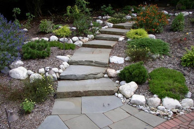 Photo of a large traditional partial sun backyard stone formal garden in New York.