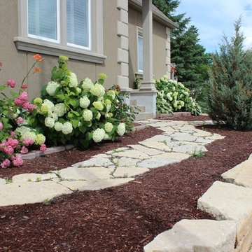 Natural Stone Path and Wall with Brown Mulch Garden