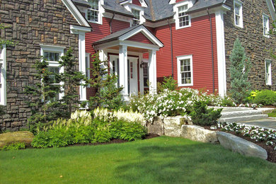 This is an example of a mid-sized rustic full sun front yard concrete paver landscaping in Boston for spring.