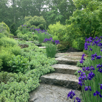 This is an example of a mid-sized rustic full sun front yard stone landscaping in Boston for spring.