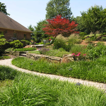 Natural stone terraces support walks and patio with meadow garden