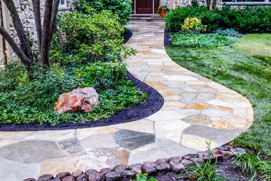Design ideas for a large traditional front yard stone garden path.