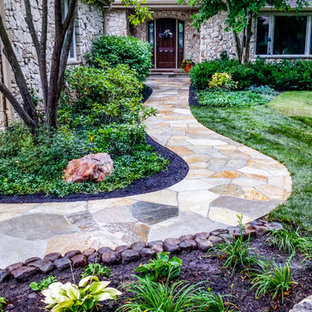 Design ideas for a large traditional front yard stone garden path.