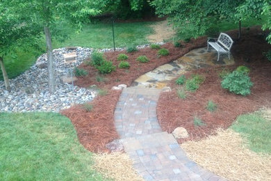 This is an example of a mid-sized transitional shade backyard stone garden path in Other.