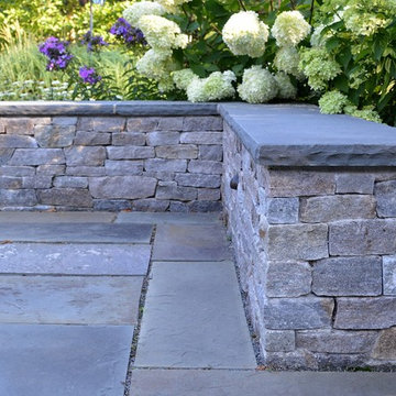 New England fieldstone veneer stone seat wall with bluestone cap.
