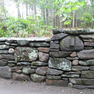 New England fieldstone wall with battered pier and low voltage lighting.