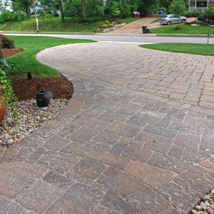 Photo of a large traditional partial sun front yard concrete paver driveway in St Louis for summer.