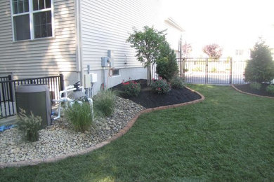 Photo of a mid-sized drought-tolerant and shade side yard stone landscaping in Philadelphia.
