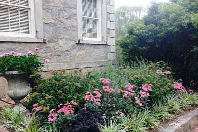Design ideas for a mid-sized traditional partial sun backyard formal garden in Providence.