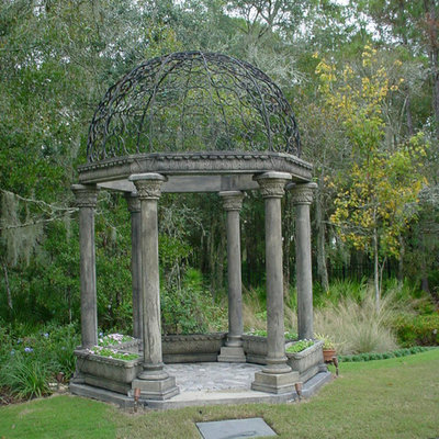 Photo of a large mediterranean drought-tolerant and partial sun backyard stone landscaping in Tampa.