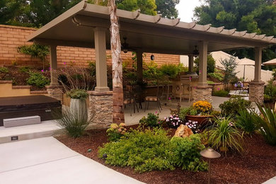 Medium sized rustic back partial sun garden for spring in San Diego with a garden path and concrete paving.