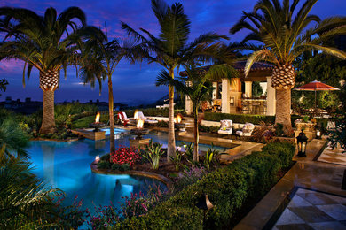 This is an example of a tropical full sun backyard landscaping in Orange County.