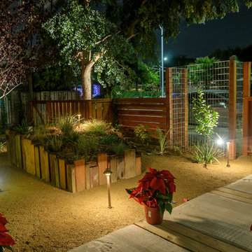 Night view - repurposed raised planters and custom fencing.