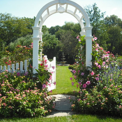 Photo of a mid-sized traditional partial sun backyard landscaping in Other.