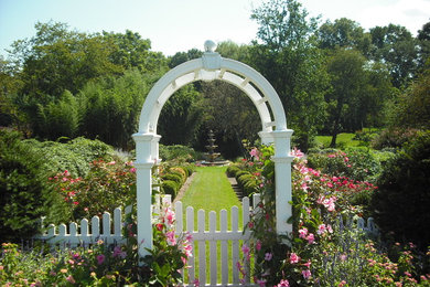 Photo of a mid-sized traditional partial sun backyard landscaping in Other.