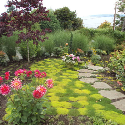 This is an example of an eclectic backyard stone landscaping in Seattle for summer.