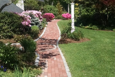 Inspiration for a mid-sized traditional side yard brick landscaping in Boston.