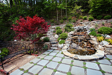 Photo of a mid-sized traditional full sun backyard stone landscaping in Charlotte for summer.