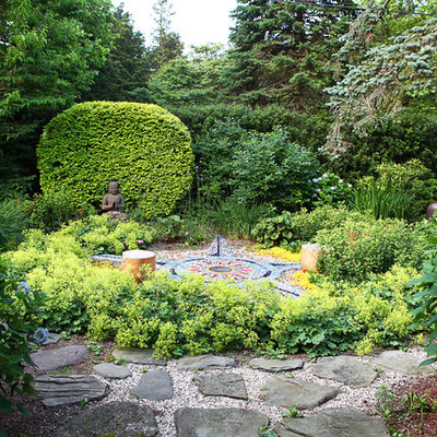 Photo of an eclectic shade backyard stone landscaping in New York.