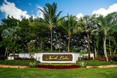 This is an example of a large tropical full sun front yard landscaping in Miami.