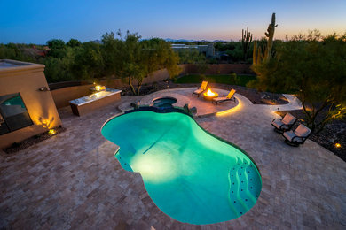 Photo of a traditional backyard stone landscaping in Phoenix.