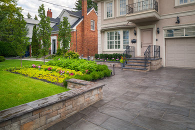 Inspiration for a large eclectic full sun front yard stone landscaping in Toronto for summer.