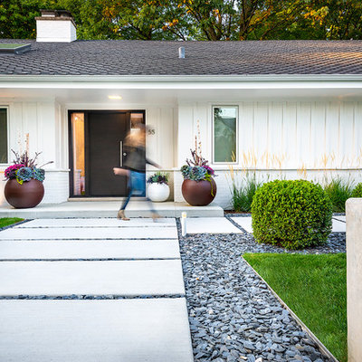 Photo of a mid-sized contemporary front yard concrete paver garden path in Chicago.