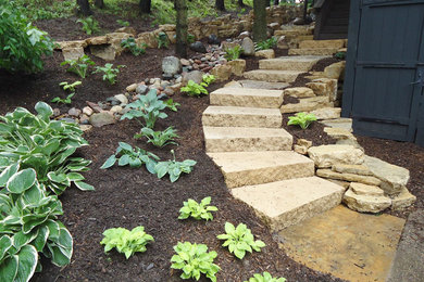 This is an example of a large rustic shade side yard stone garden path in Minneapolis.