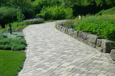 Design ideas for a large traditional shade backyard brick garden path in Cleveland for spring.