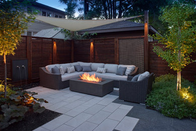 Design ideas for a small classic back patio in Toronto with a fire feature and natural stone paving.