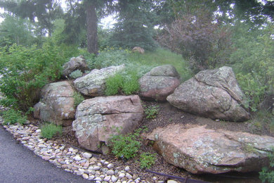 Inspiration for a large traditional full sun front yard stone landscaping in Denver for spring.